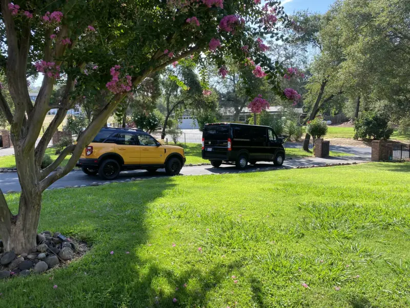Very Smooth Auto Glass van servicing a vehicle at a Lincoln, CA home