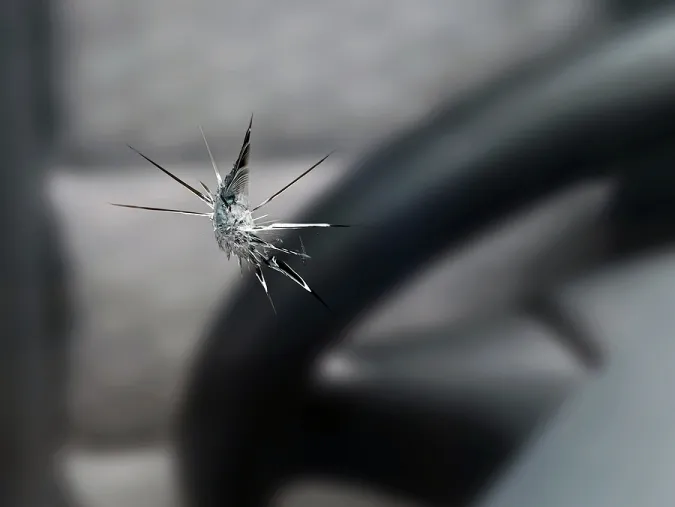 Close-up of a windshield chip before repair